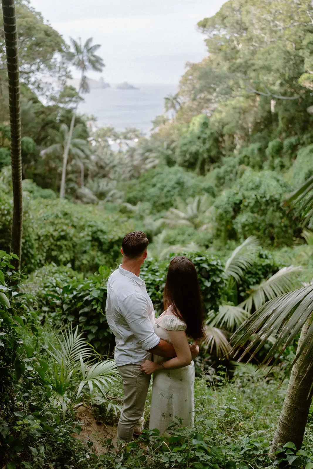 Mel and Brent facing each other in the forest, Lord Howe Island
