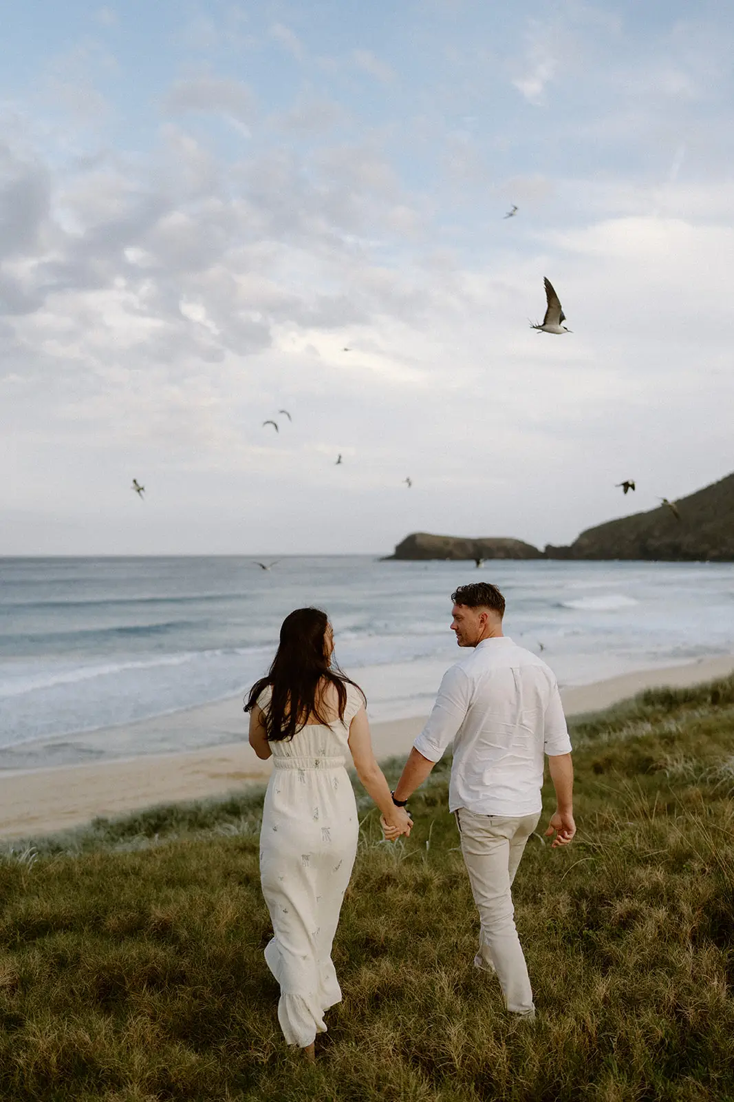 The couple walking the headland as seabirds circle, Lord Howe Island