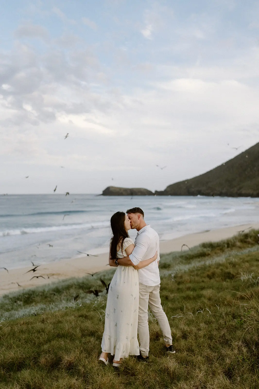 Mel and Brent embracing on the headland, Lord Howe Island
