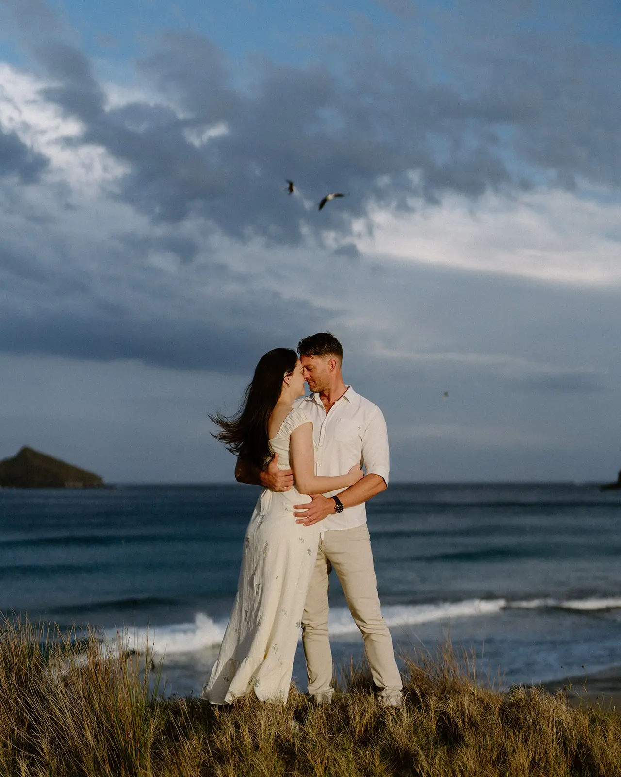 Mel and Brent kissing above the ocean, Lord Howe Island