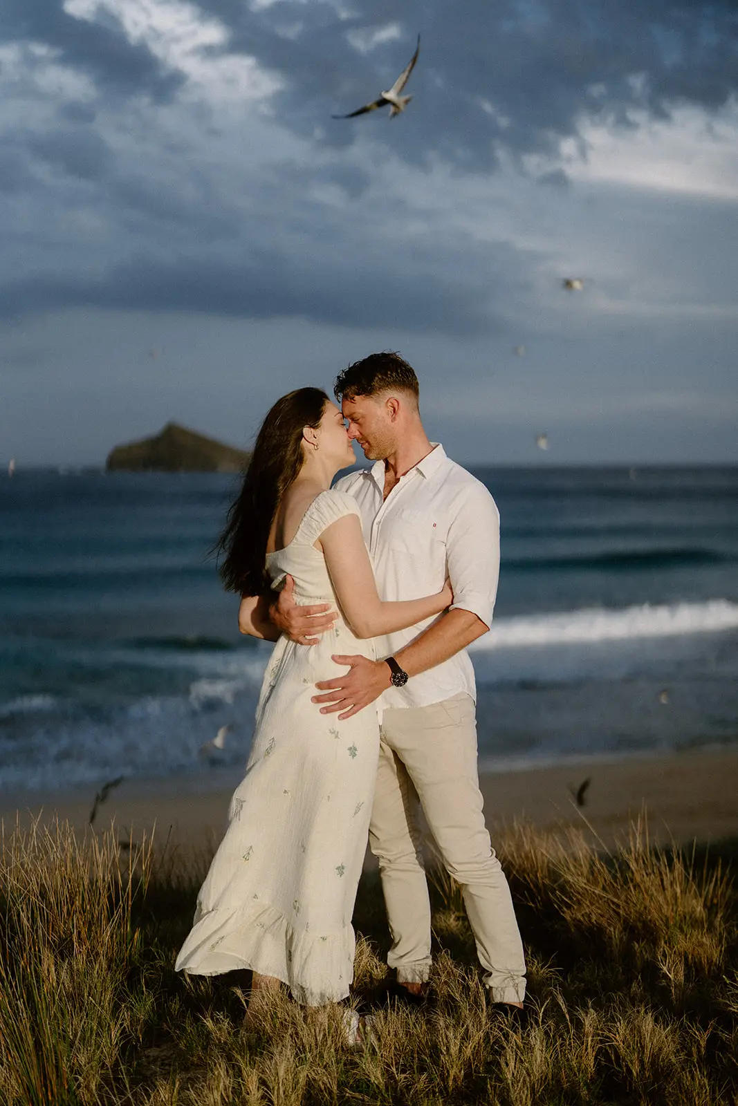 Mel and Brent at dusk with an offshore islet behind, Lord Howe Island