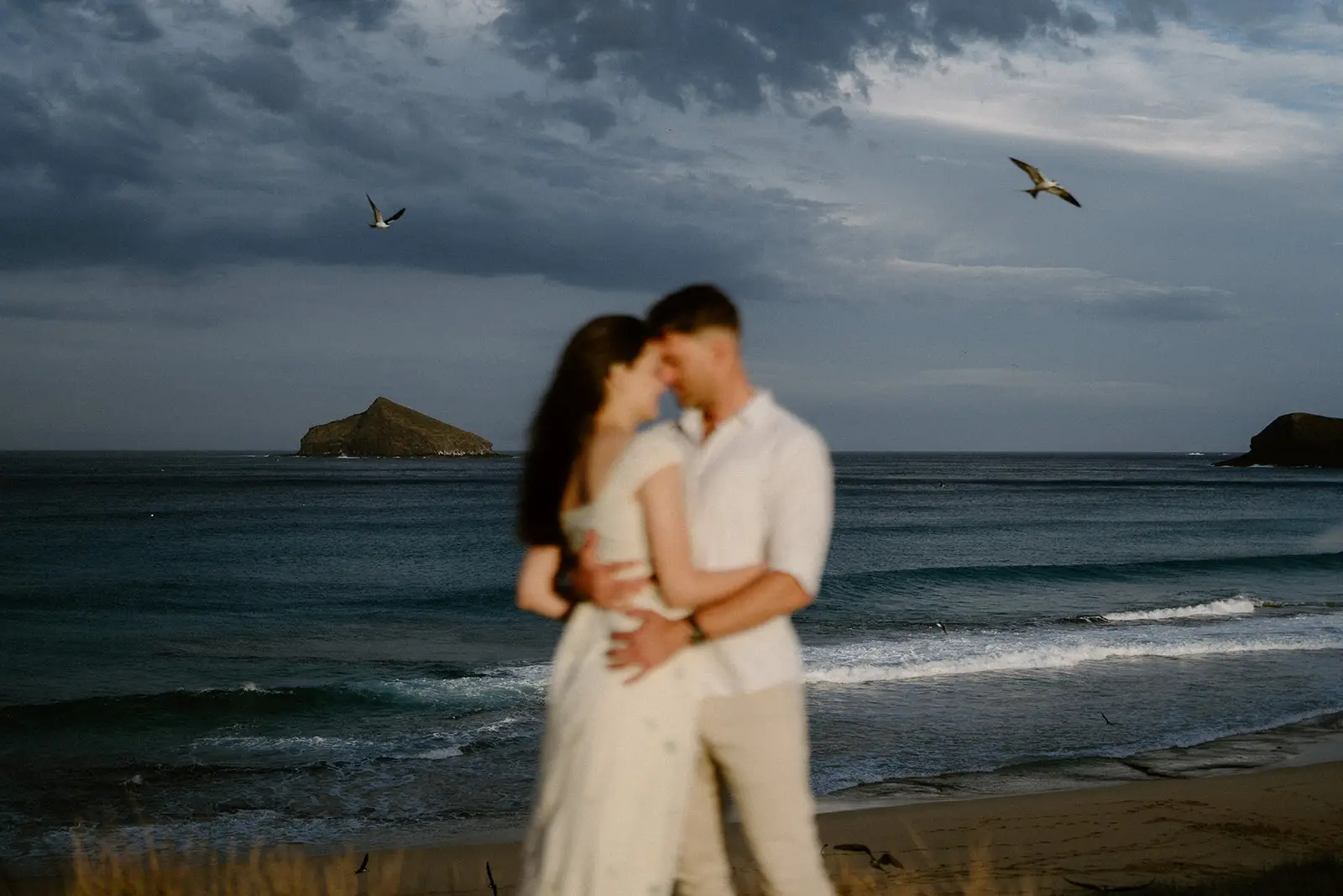 The couple embracing against a stormy sea, Lord Howe Island
