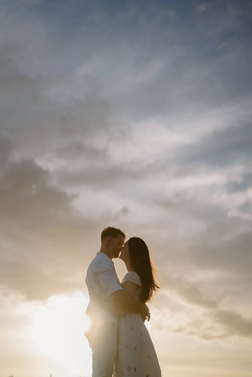 Mel and Brent silhouetted in golden light, Lord Howe Island