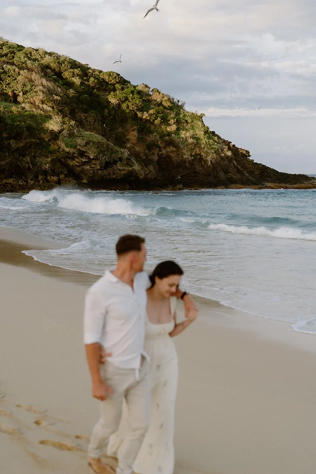 Mel and Brent walking the beach below the headland, Lord Howe Island