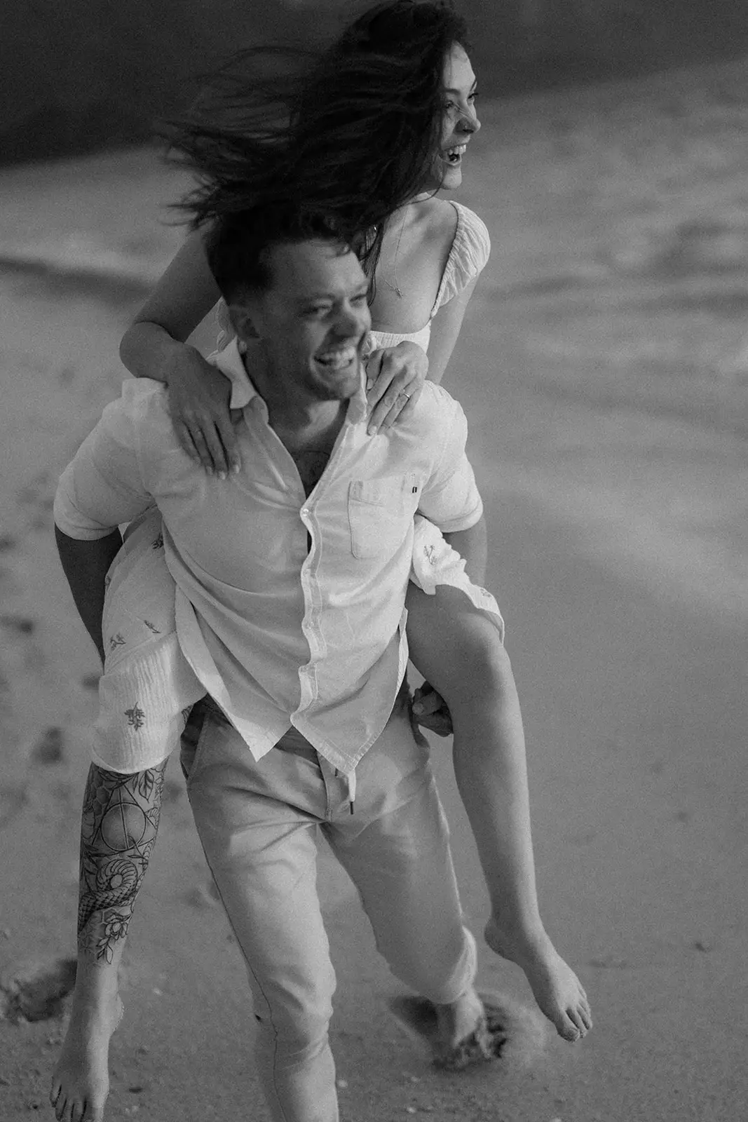 Mel and Brent laughing together on the beach, Lord Howe Island
