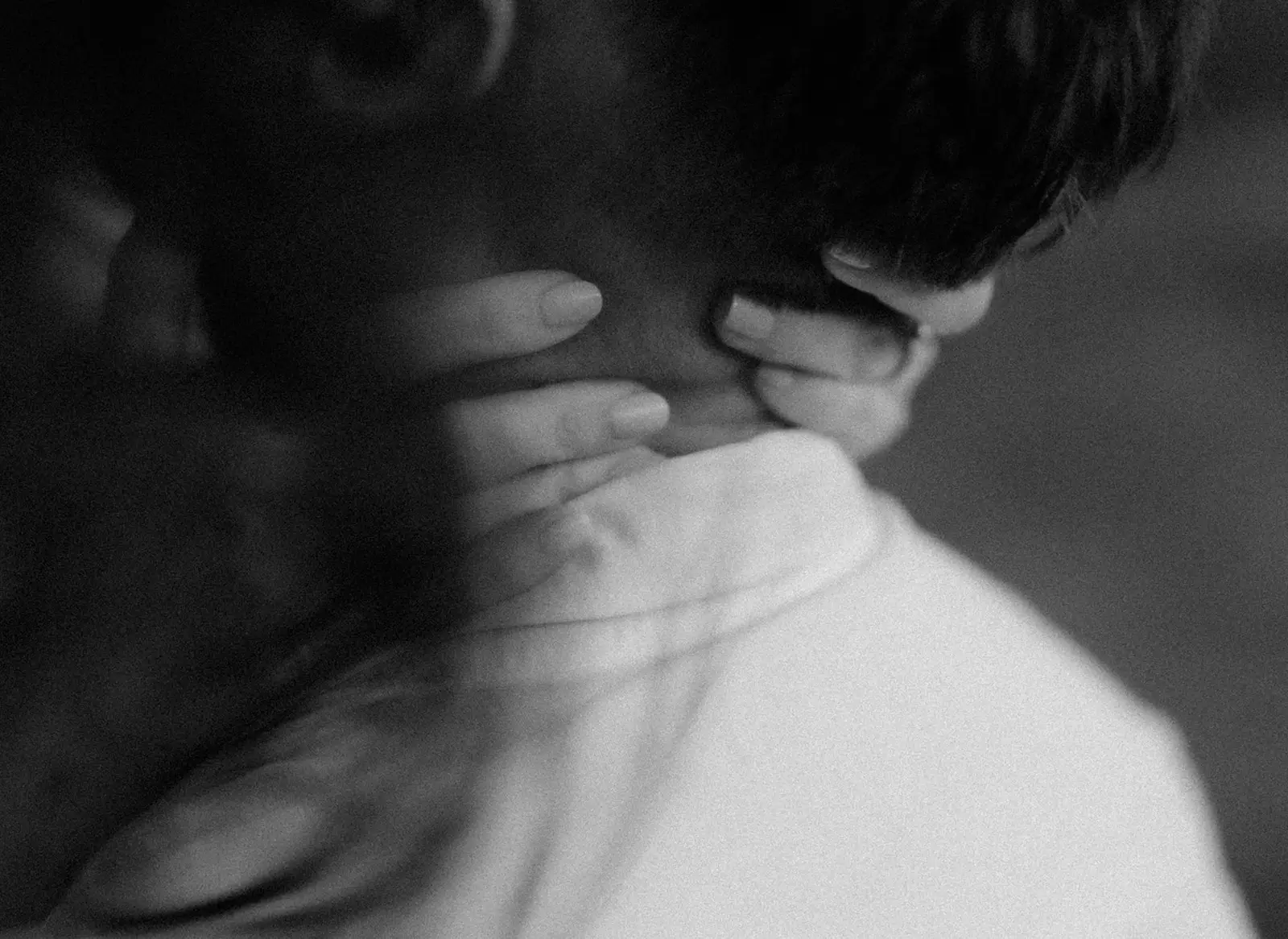 Close black and white portrait of Mel and Brent, her hand at his neck, Lord Howe Island