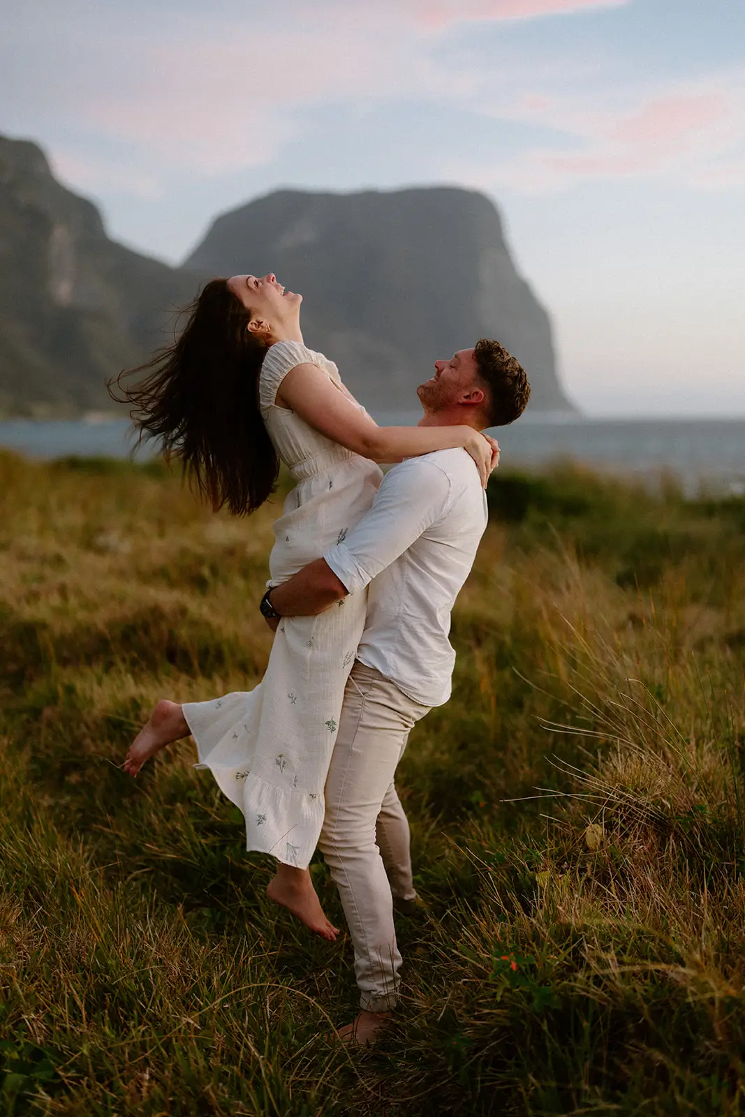 Brent lifting Mel with Mount Gower behind, Lord Howe Island