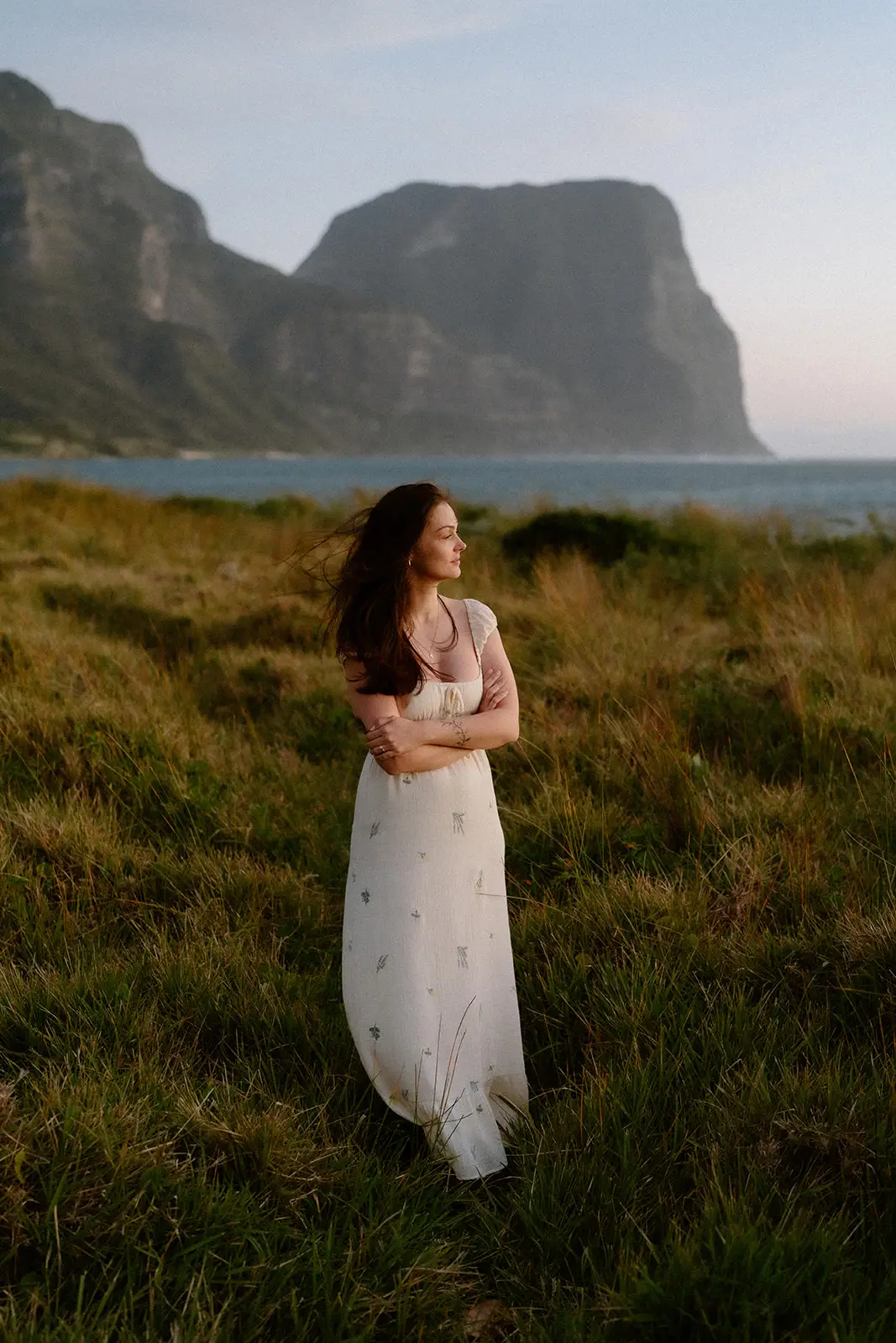 Mel in the grass with the mountains behind, Lord Howe Island