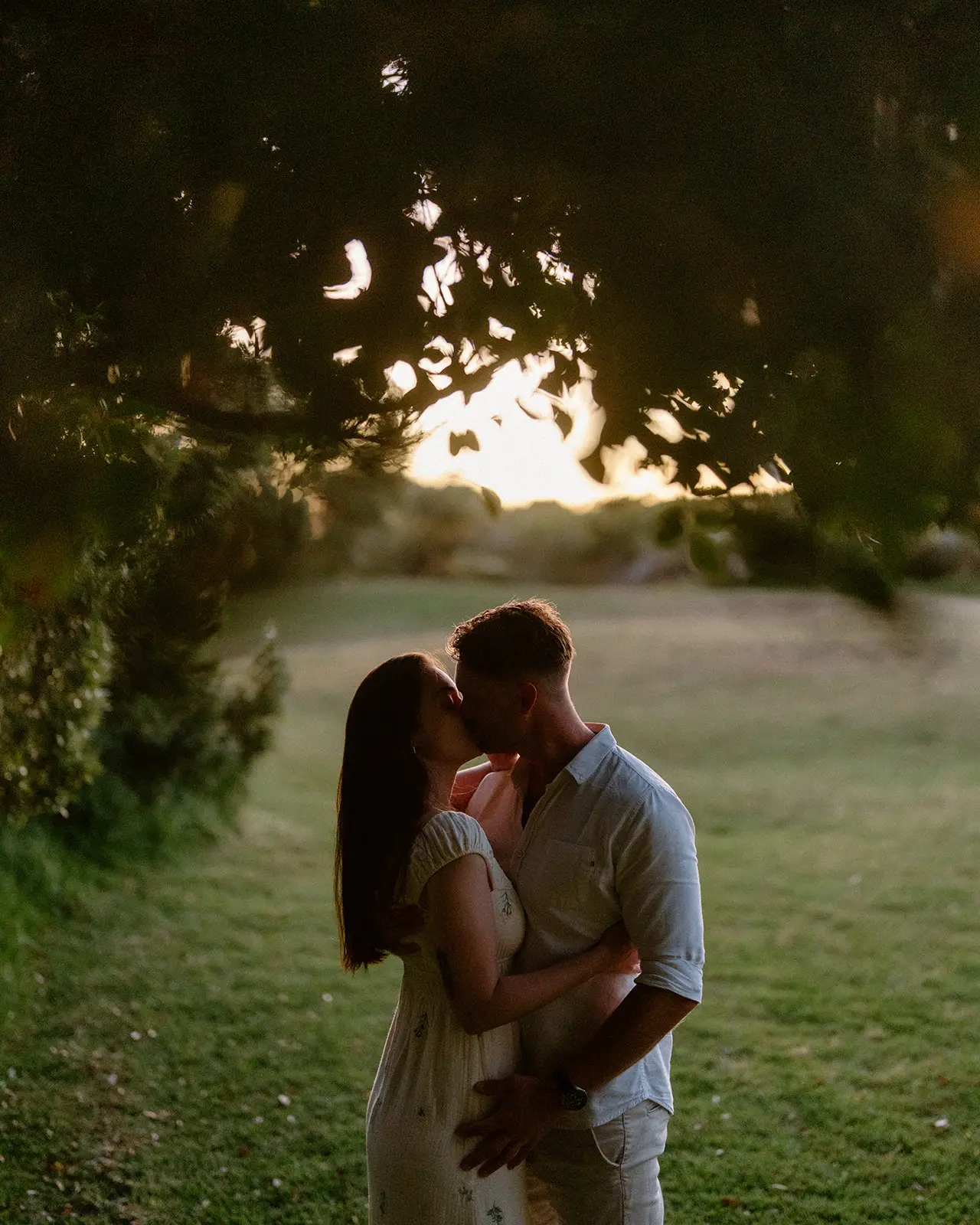 The couple kissing under a tree as the sun drops, Lord Howe Island
