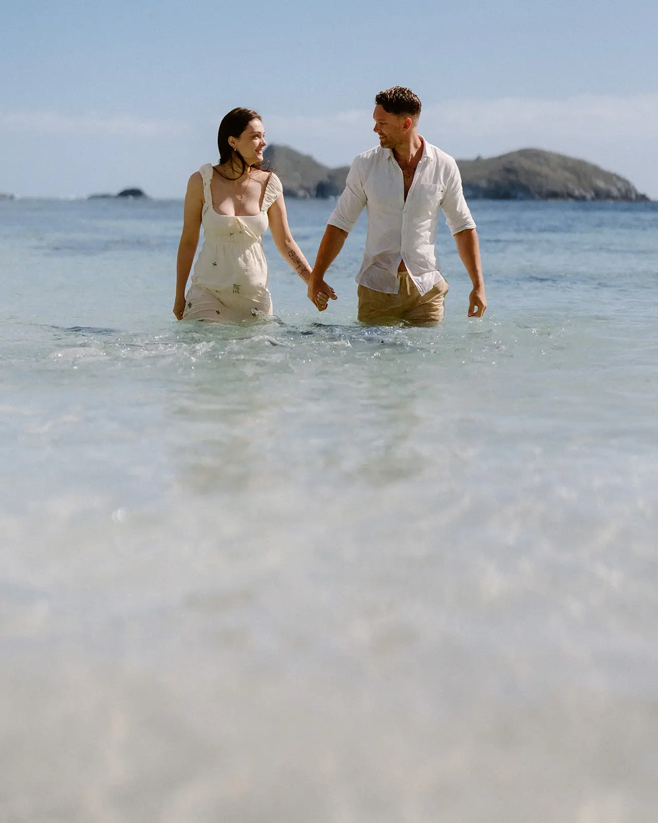 Mel and Brent standing in the lagoon with the islets behind, Lord Howe Island