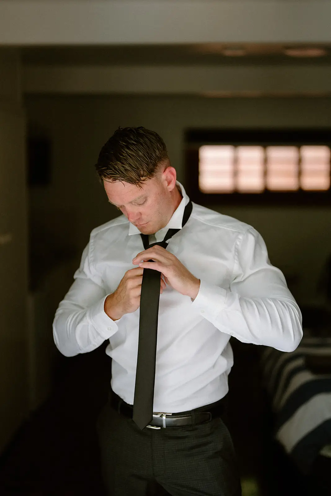 Brent fixing his tie before the wedding, Lord Howe Island