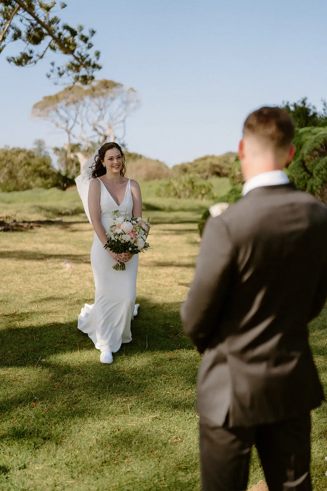Mel walking across the lawn to Brent, Lord Howe Island