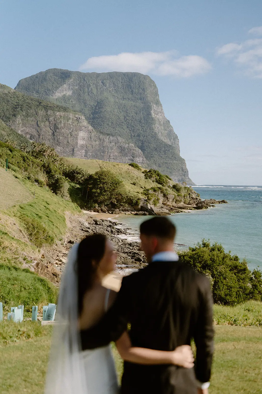 The newlyweds embracing beneath the mountain, Lord Howe Island