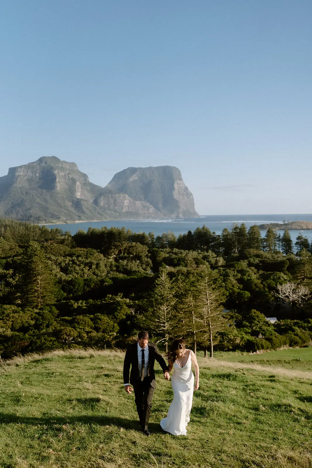 Mel and Brent in the grass with the mountain behind, Lord Howe Island