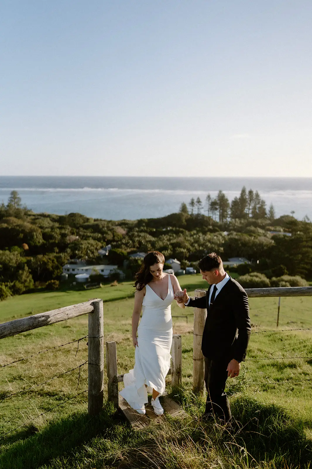 Mel and Brent at a fence line at dusk, Lord Howe Island