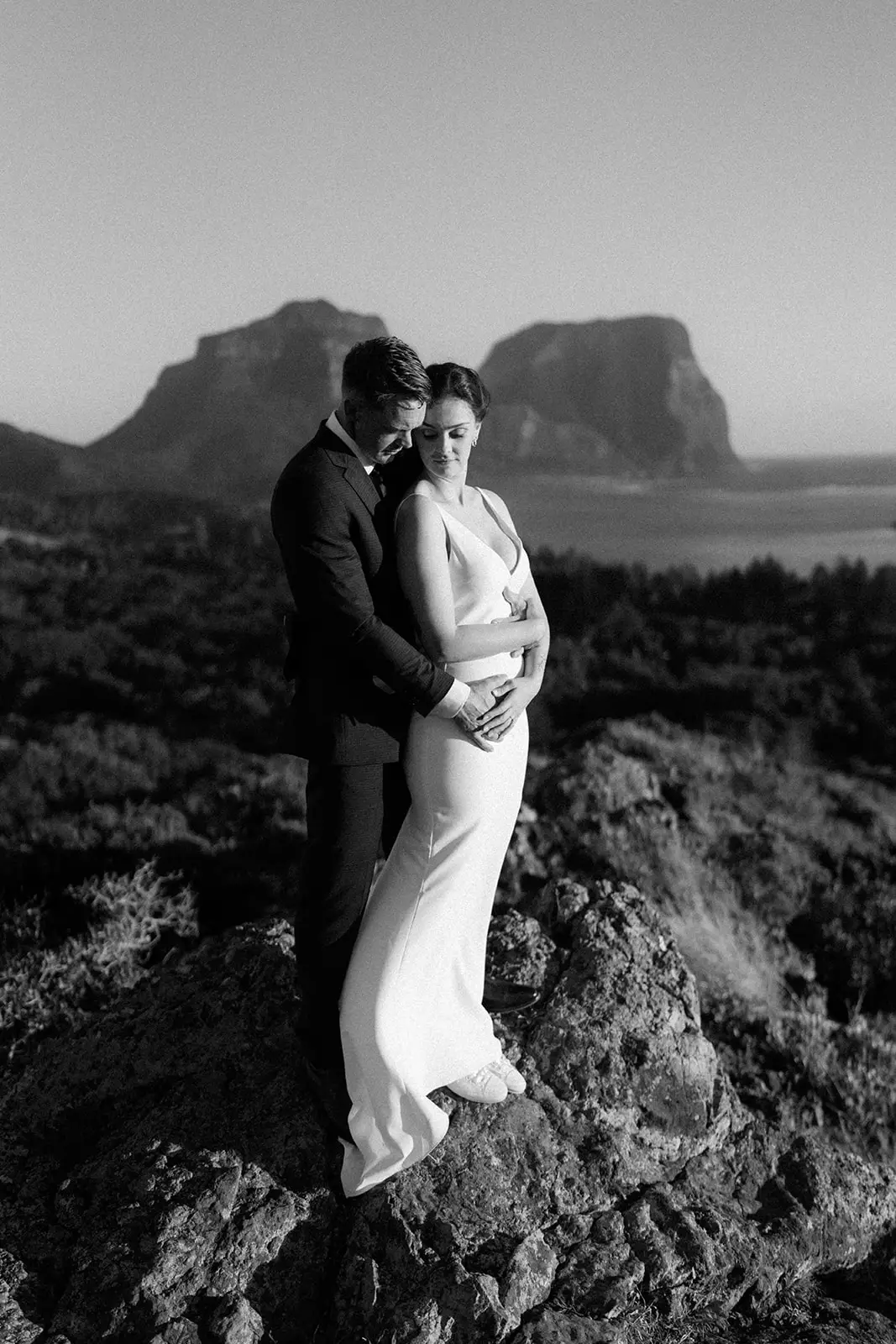 The couple embracing on the clifftop rocks, Lord Howe Island