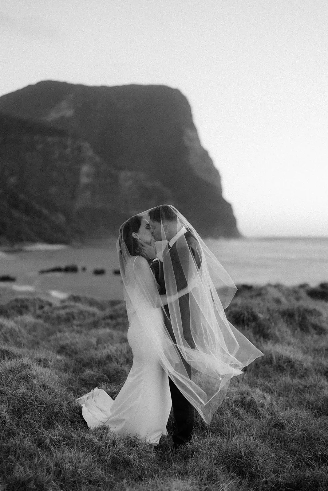 Mel and Brent kissing with the mountain behind, Lord Howe Island