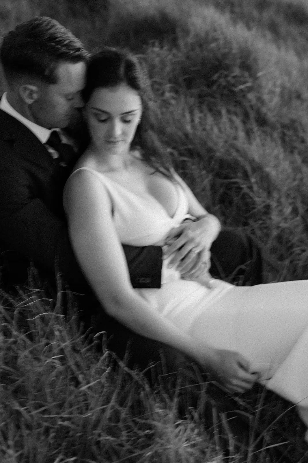 Mel and Brent sitting together in the grass, Lord Howe Island