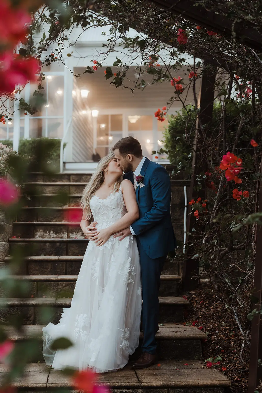 The couple on the manor steps beneath the flowering arch, Maleny Manor