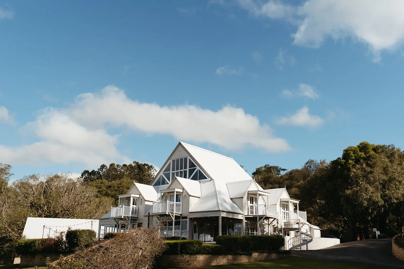 The white manor with its steep gables above the Sunshine Coast hinterland, Maleny Manor