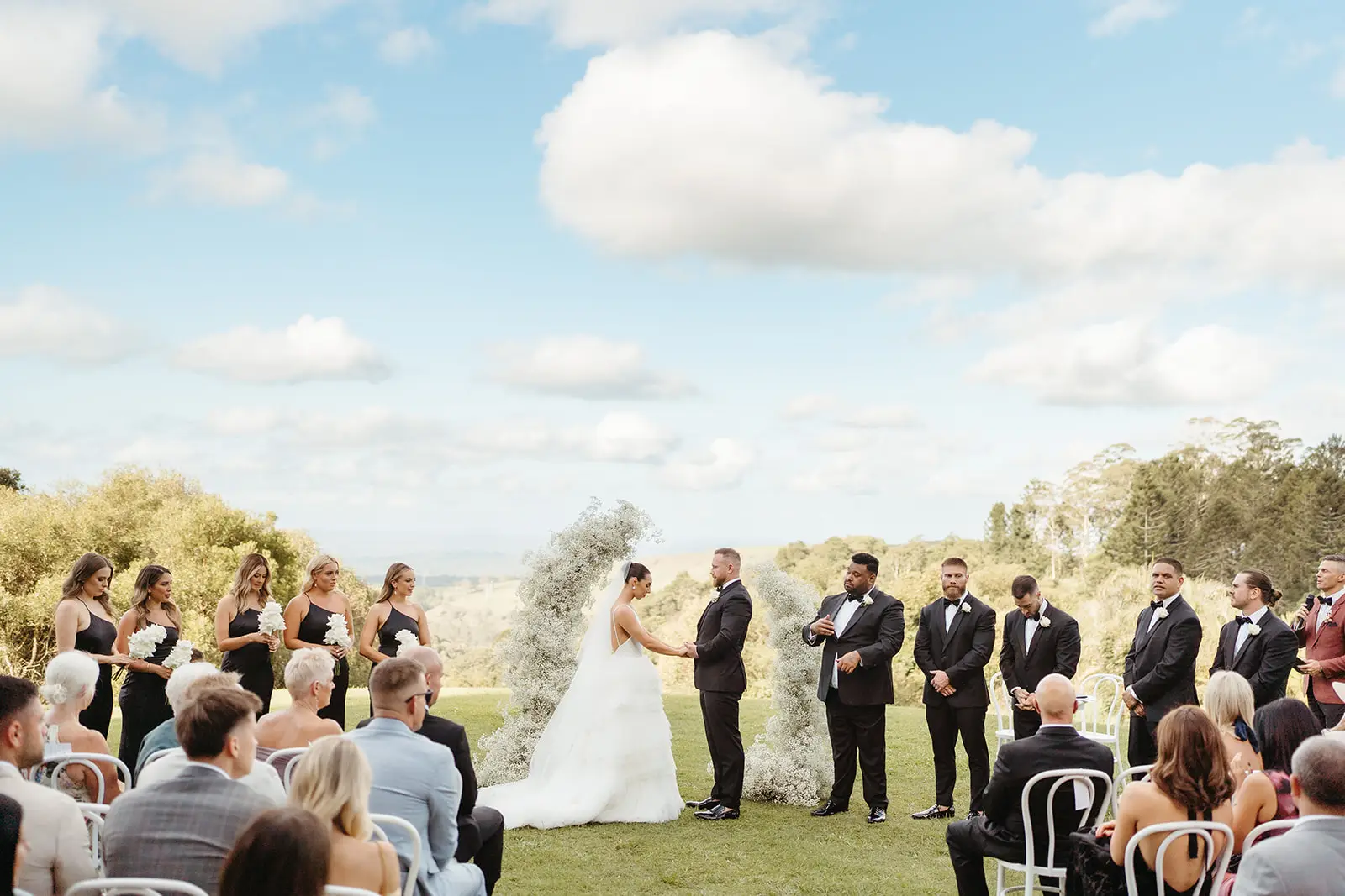 The ceremony on the open lawn, guests seated with the ranges beyond, Maleny Manor