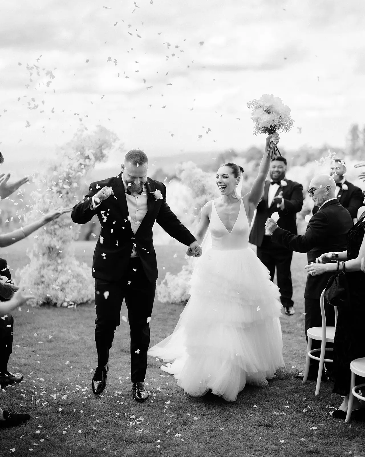 Black and white — confetti as they come back up the aisle, Maleny Manor