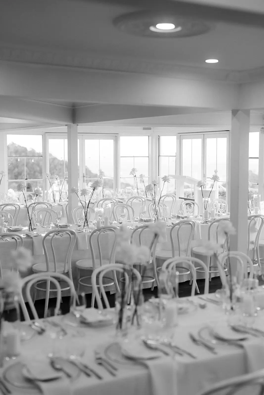Black and white — the pavilion set with round tables and bentwood chairs, Maleny Manor