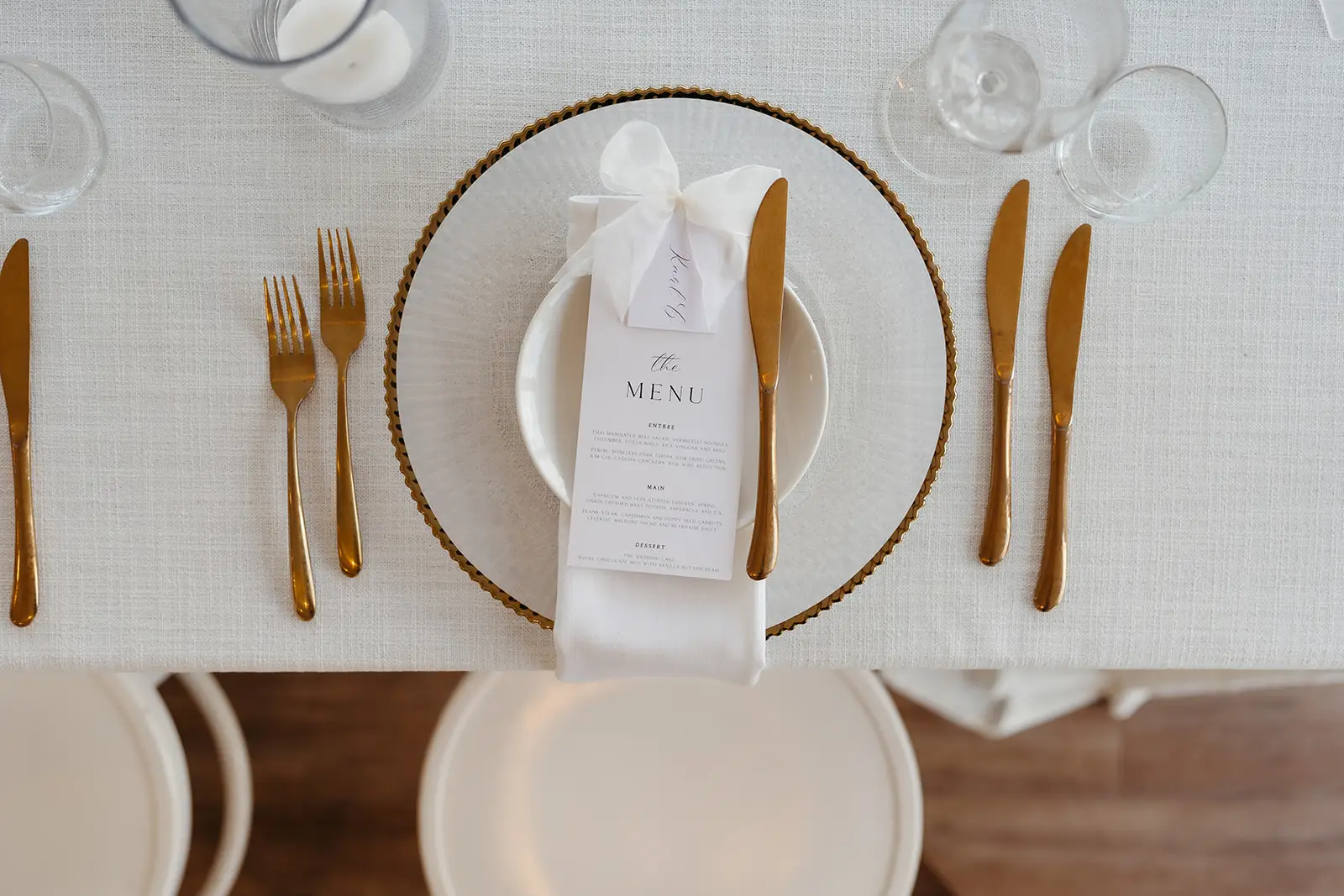 A place setting with gold cutlery and a printed menu, Maleny Manor