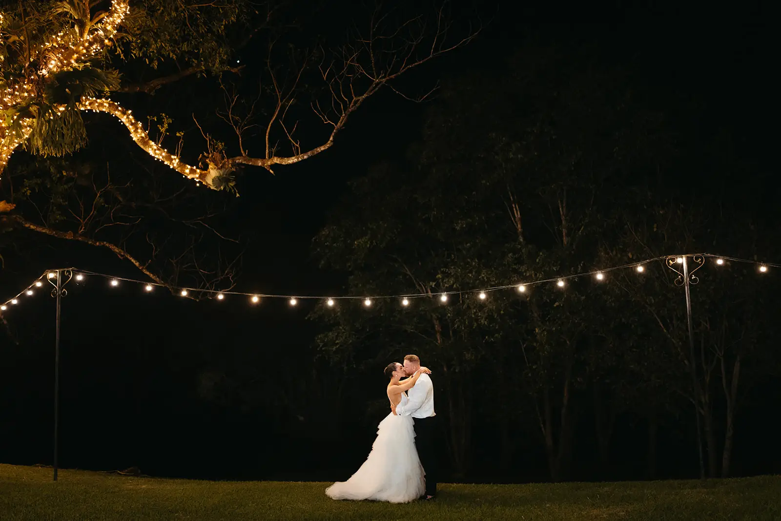 The two of them alone under the festoons on the lawn after dark, Maleny Manor