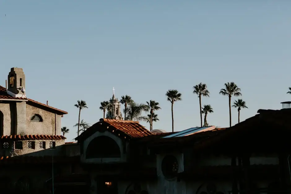 The tiled rooftops and palms of the Mission Inn against the sky, Riverside