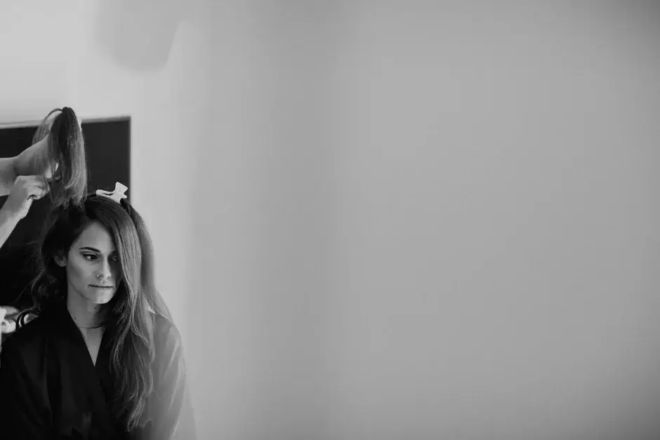 Amanda by the window having her hair done, black and white