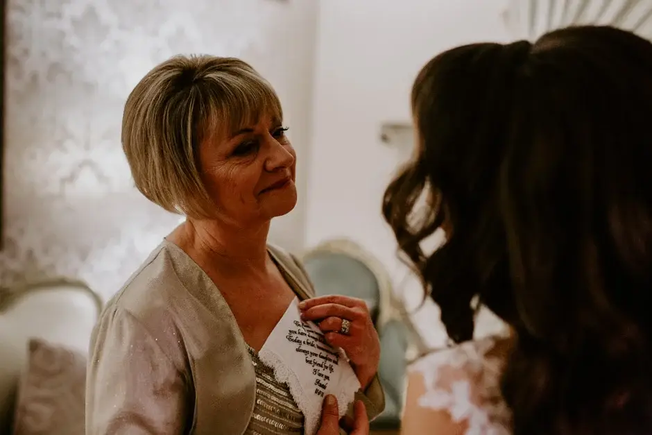 Amanda’s mother pinning something to her gown, Riverside