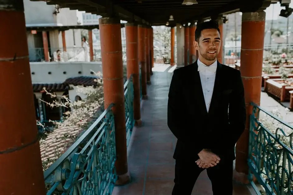 Aaron waiting in the tiled colonnade in his tuxedo, Riverside