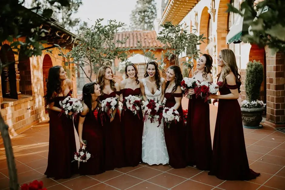Amanda with her bridesmaids in burgundy in the courtyard, Riverside