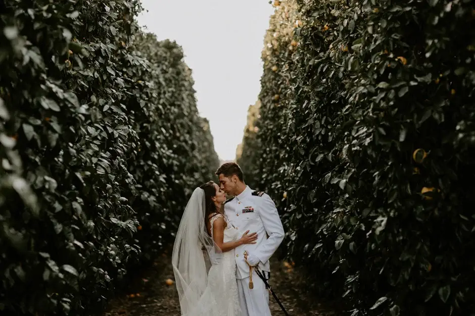 Aaron and Amanda kissing in a citrus grove, California