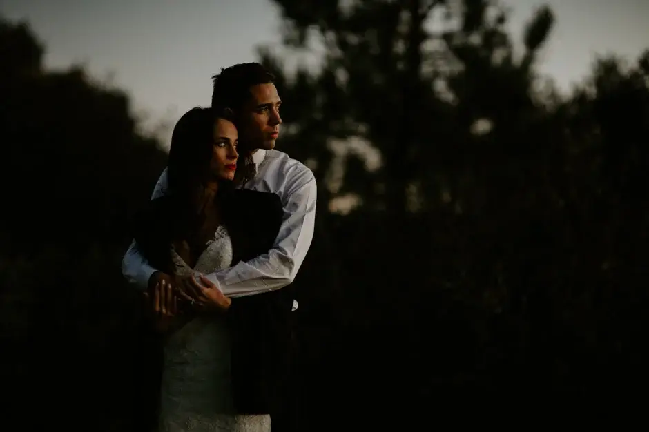 Aaron holding Amanda from behind at dusk, California