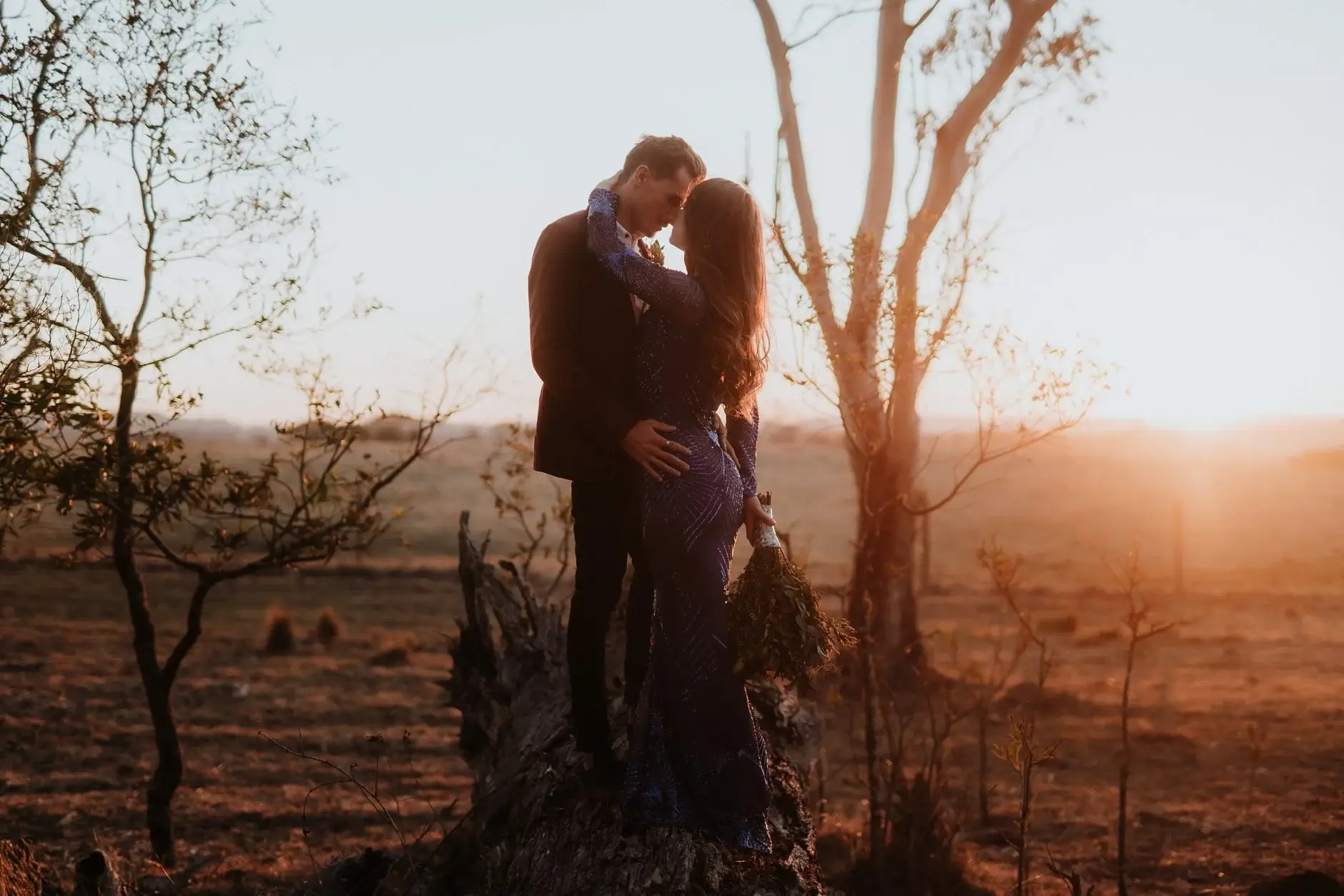 Jess and Drew in the low sun among fire-blackened trees, New England National Park