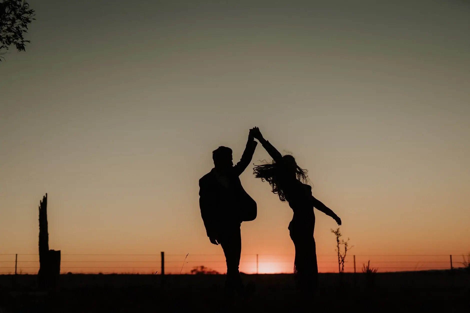 Jess and Drew dancing in silhouette against the sunset, New England