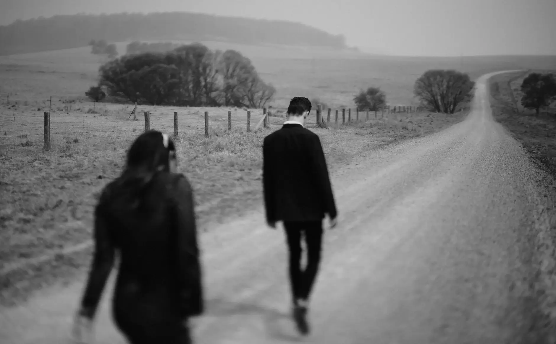 Walking away down the road together, black and white, New England