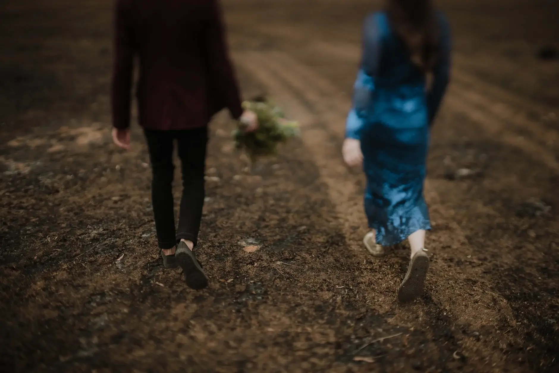 Walking away across the ash, bouquet in hand, New England