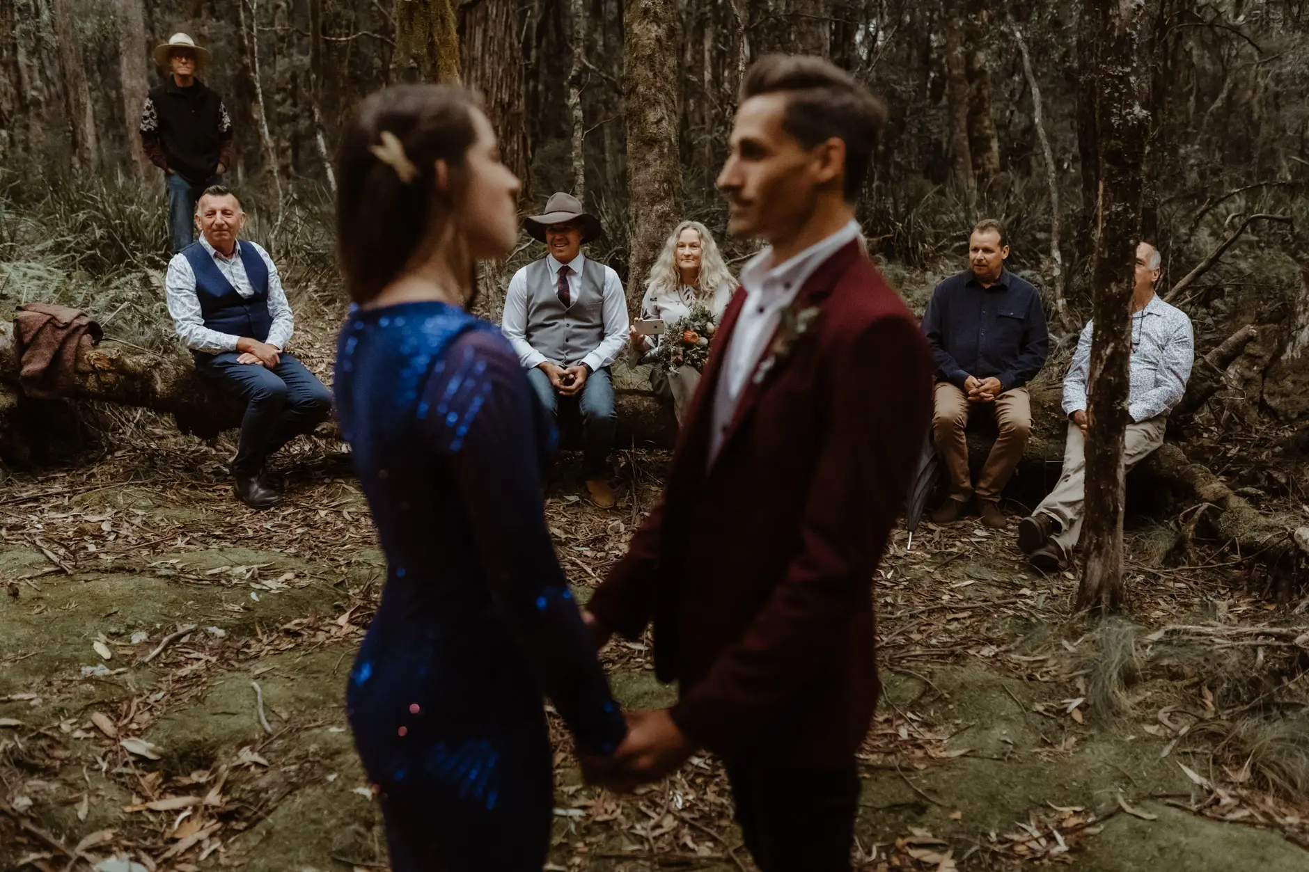 Jess and Drew holding hands during the ceremony, New England