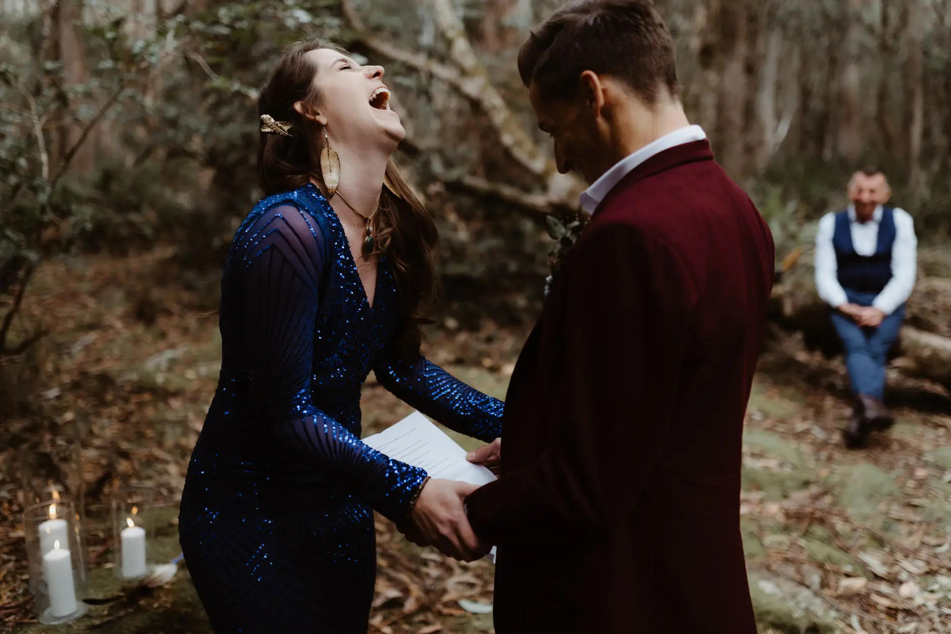 Jess laughing during the vows, candles at their feet, New England