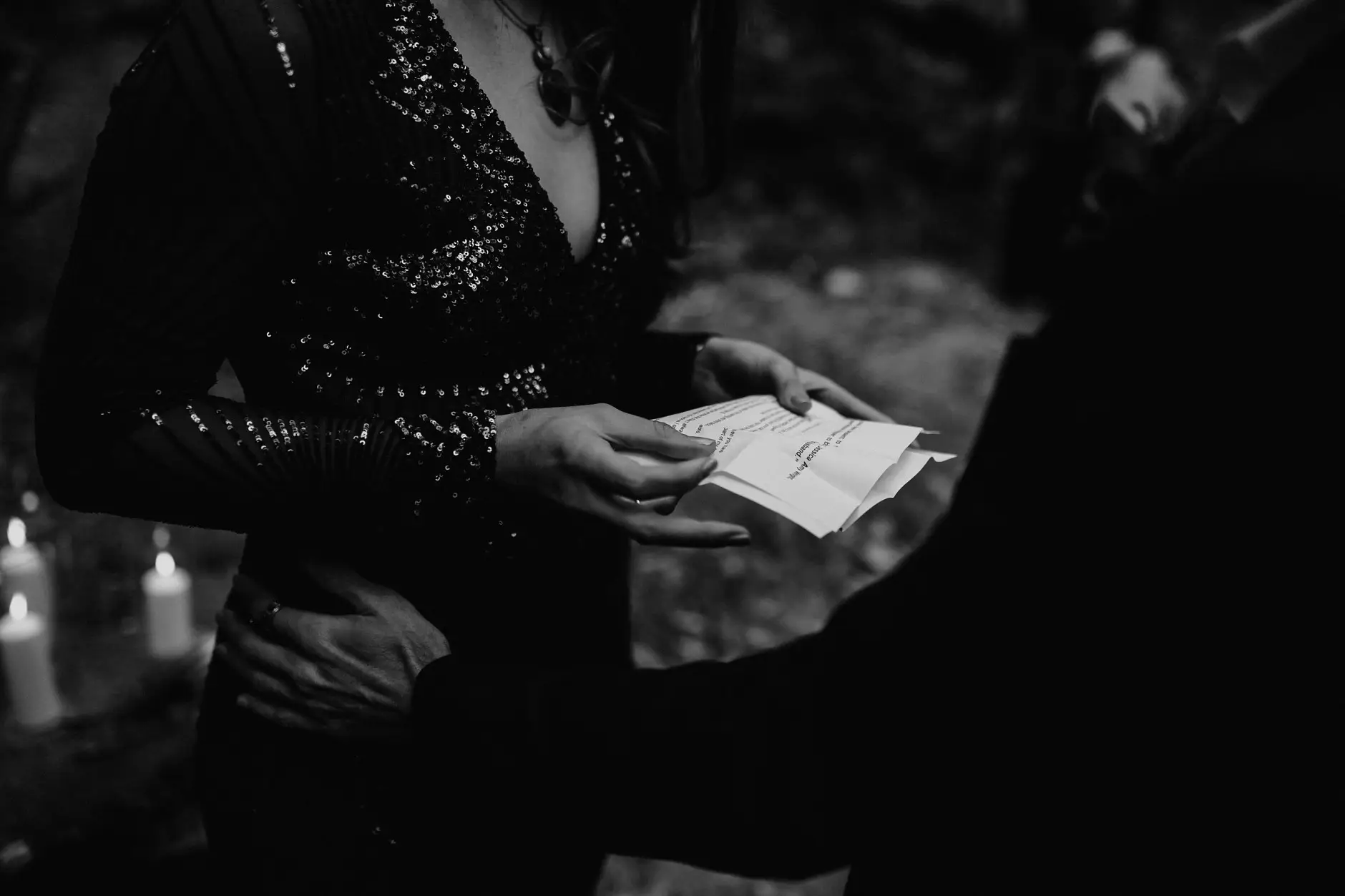Reading vows by candlelight, black and white, New England