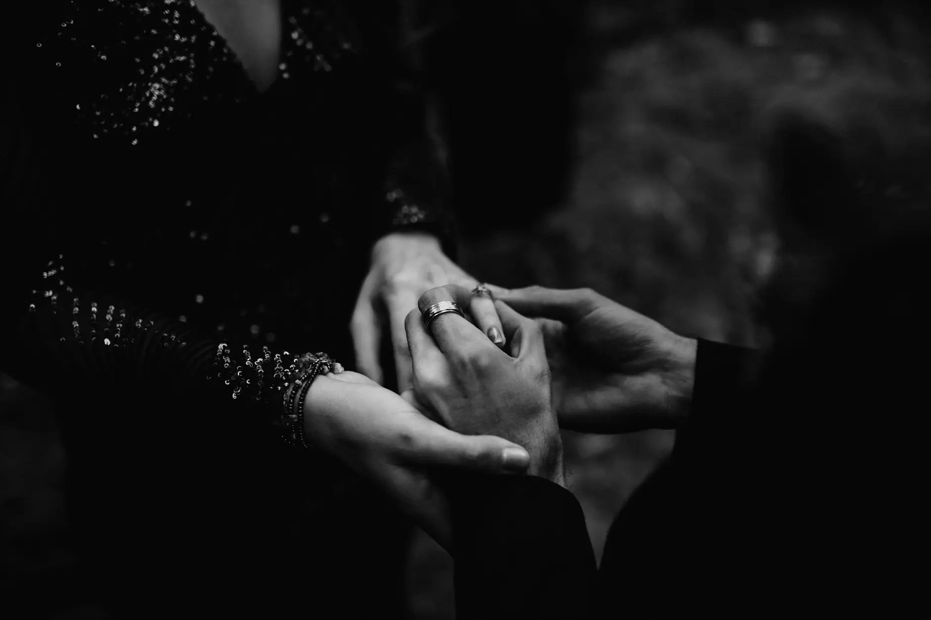 Her hands cupped in his after the rings, black and white, New England