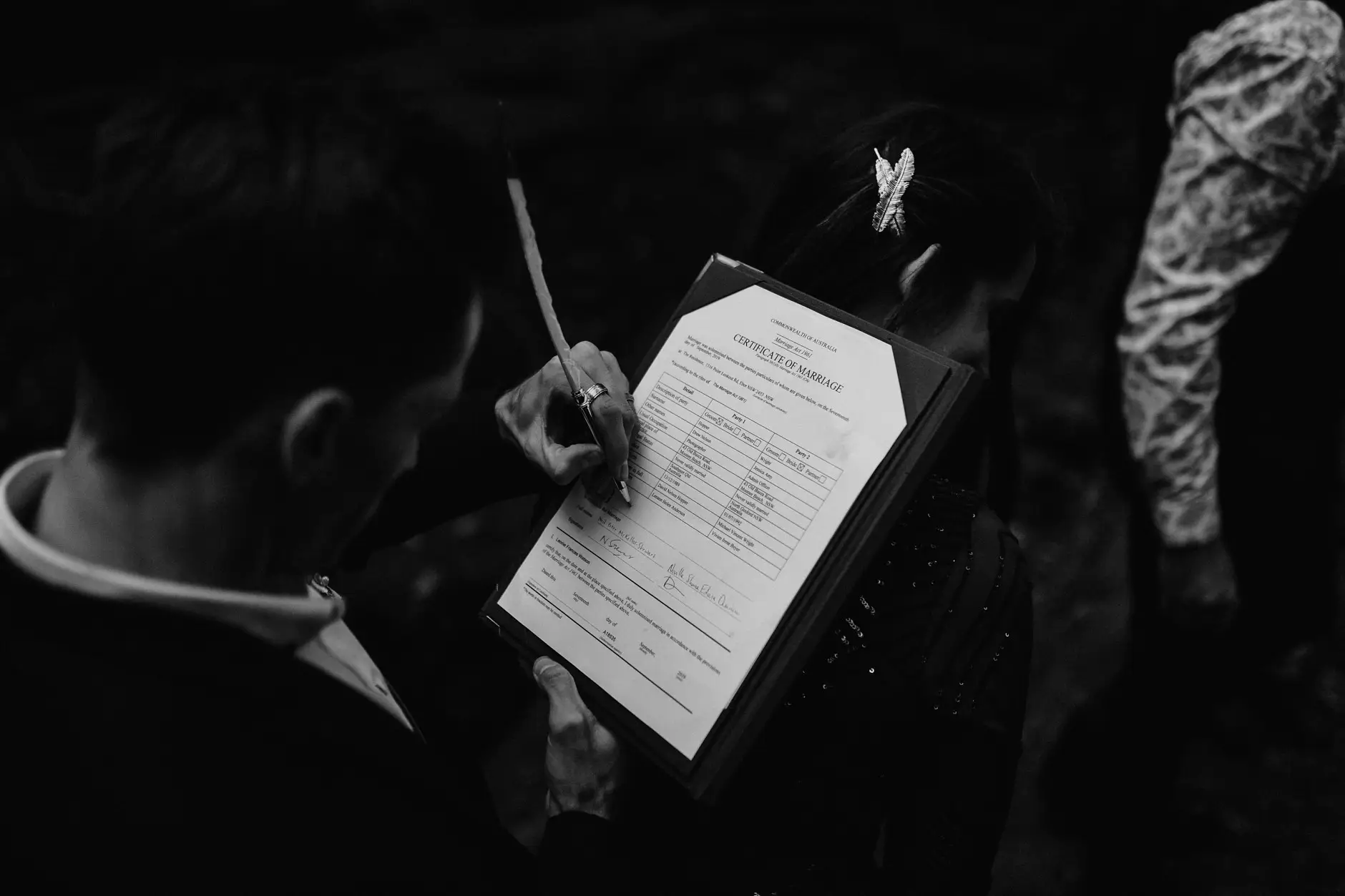 Signing the marriage certificate in the forest, black and white