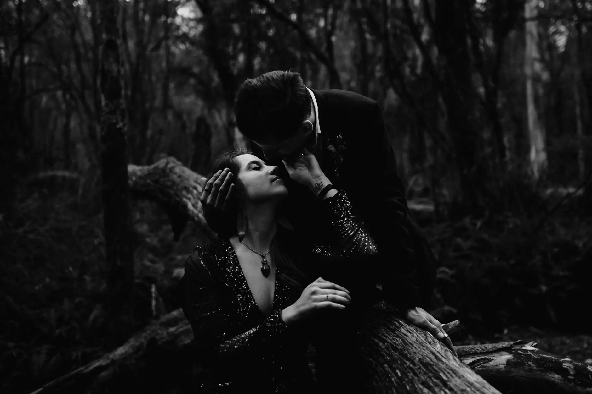A kiss against a fallen log, black and white, New England