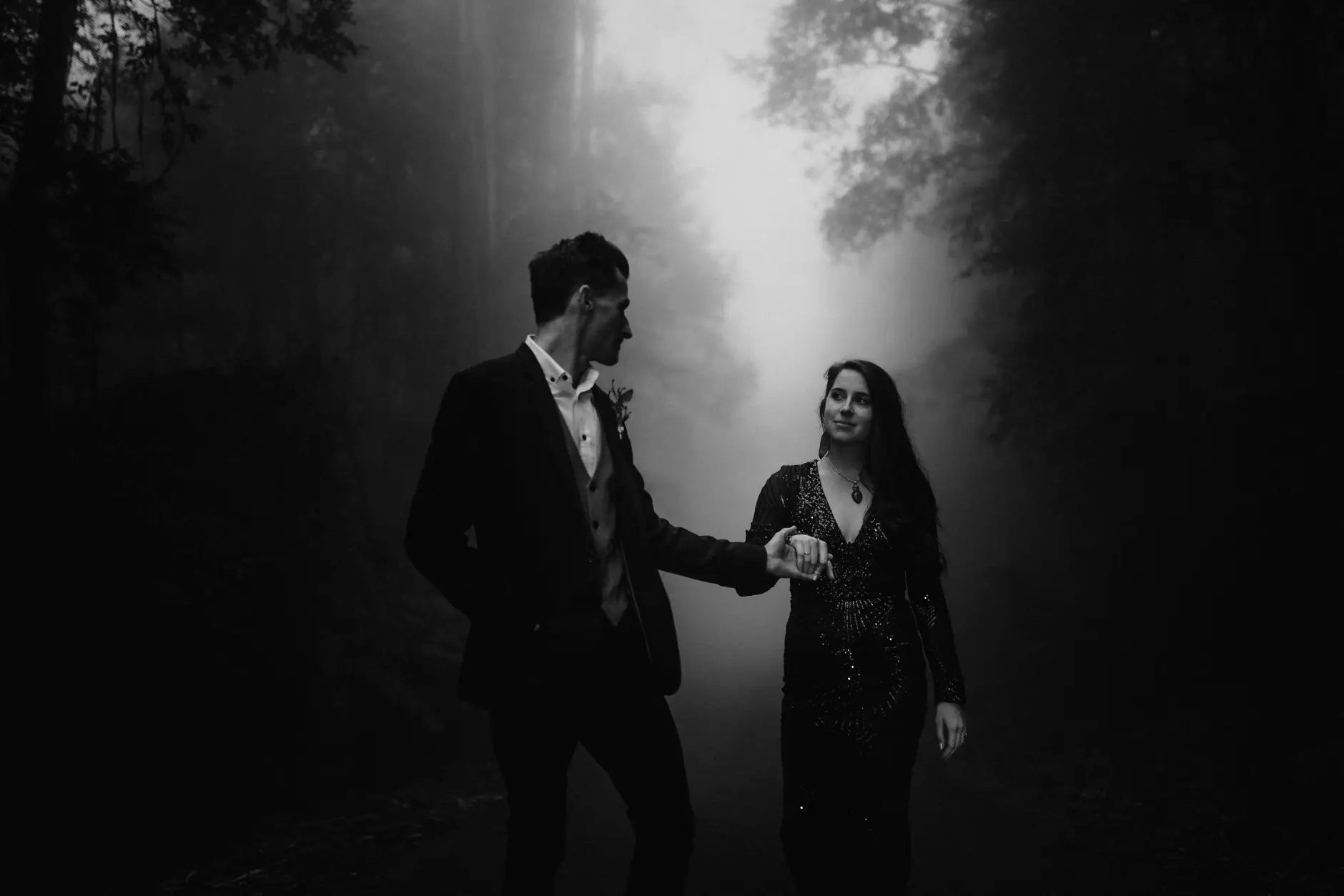Holding hands in the misty forest, black and white, New England