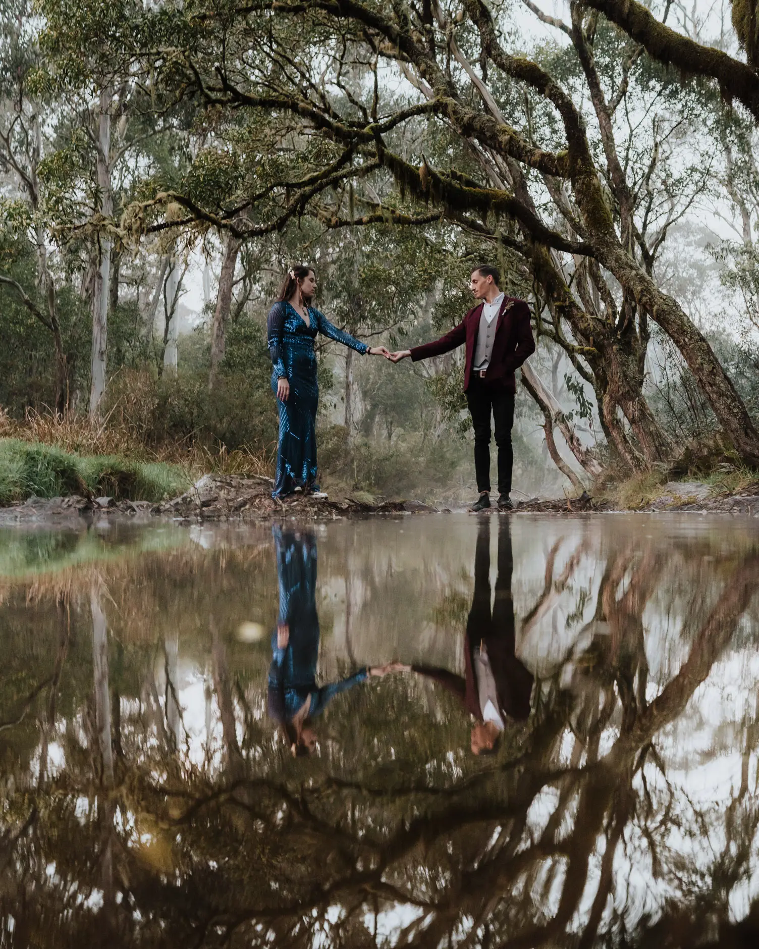 Standing at the creek with their reflection below, New England