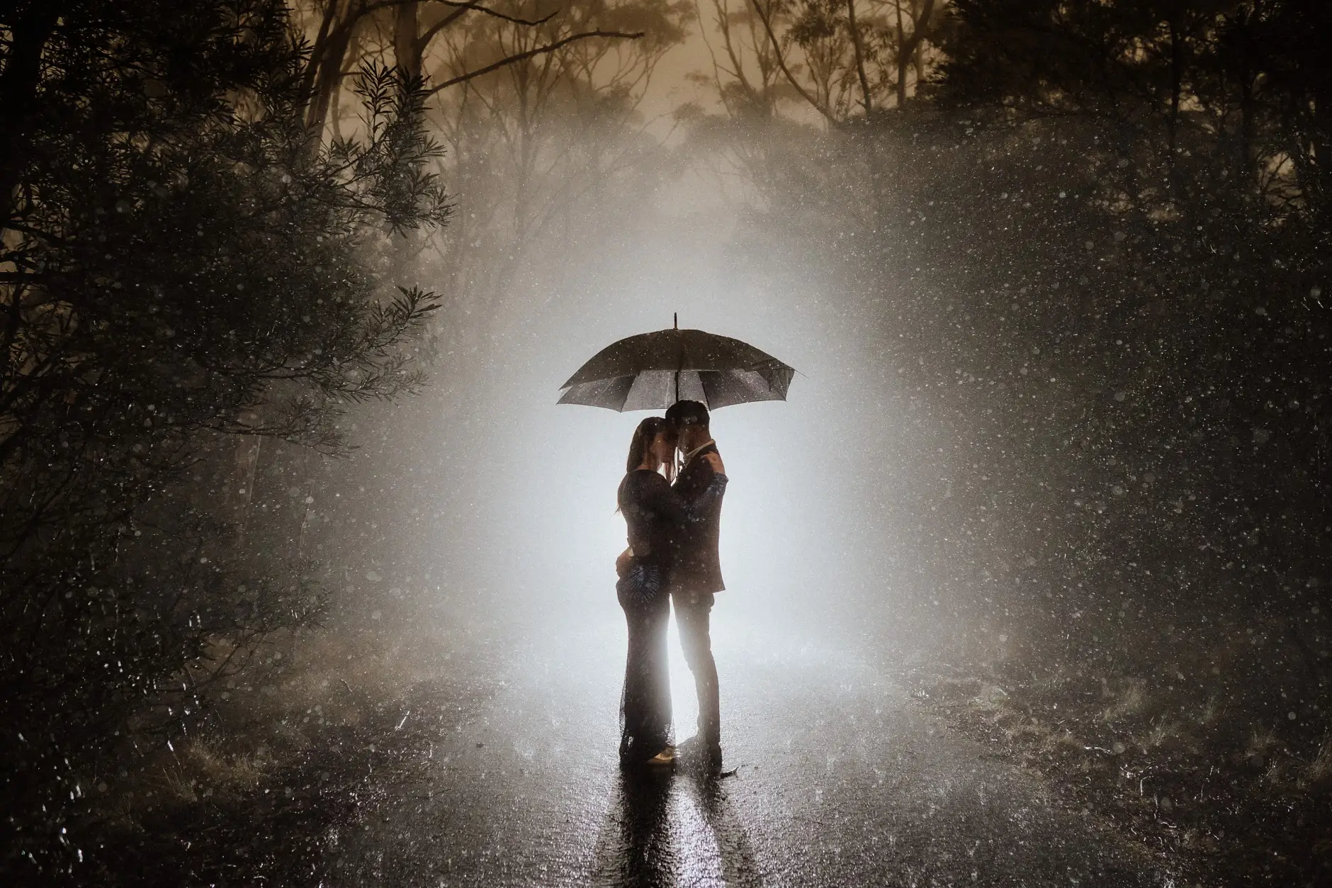 Under an umbrella in the rain, backlit on the road, New England