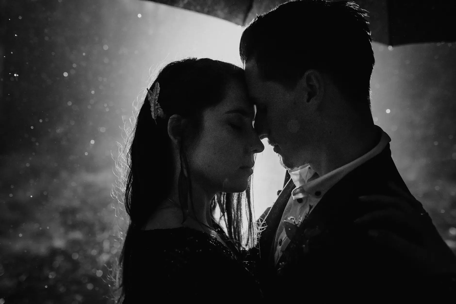 Foreheads together in the rain, black and white, New England